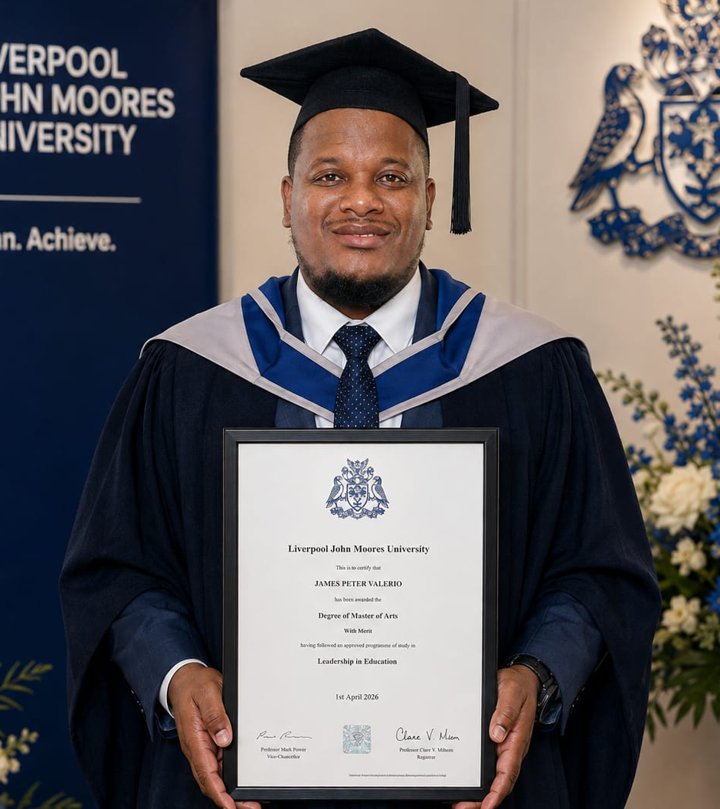 James Valerio in graduation gown holding his Master's degree certificate